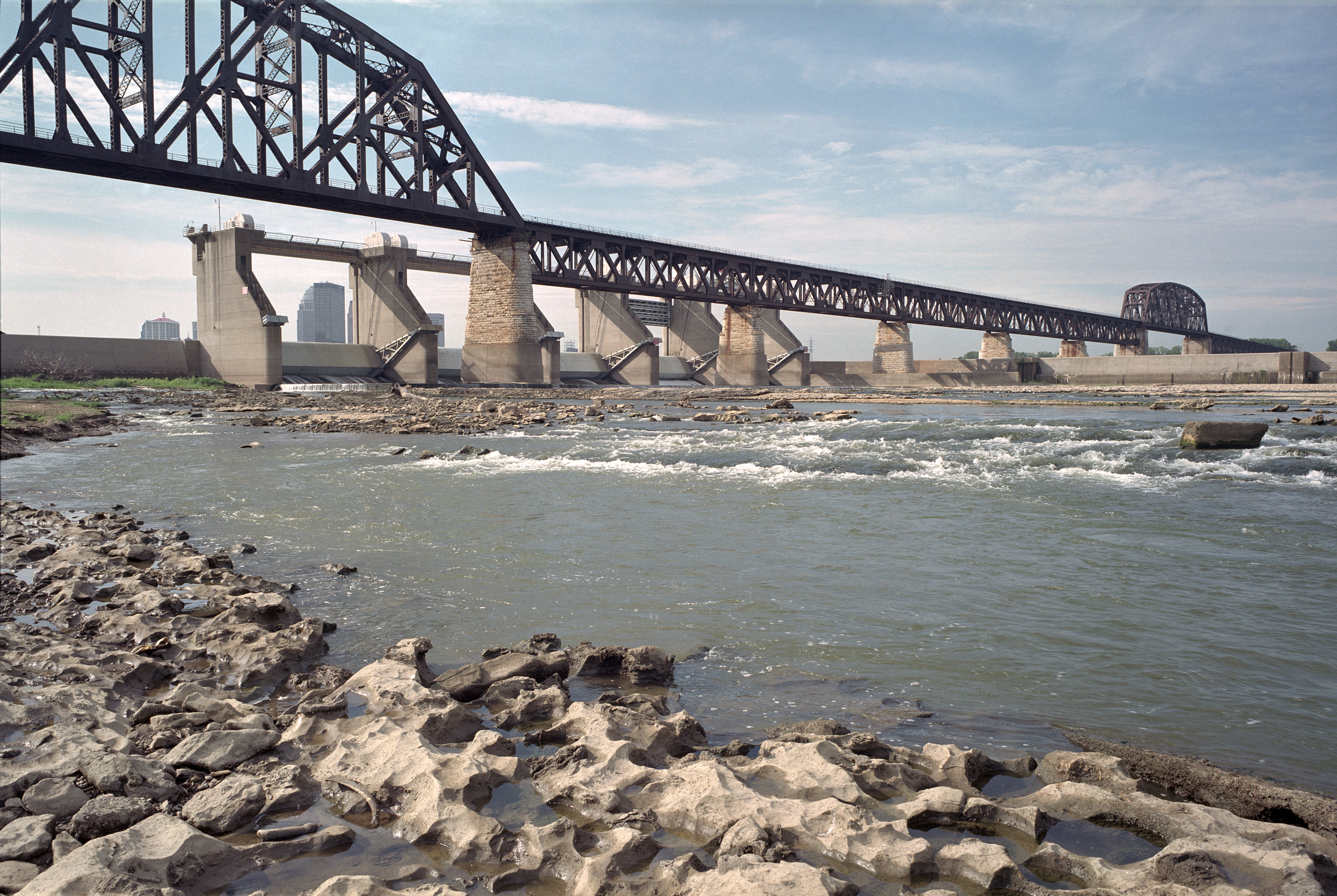 Looking south from the Falls of the Ohio: water-cut Devonian limestone in the foreground, Louisville on the far bank. Before the dam, these rapids dropped about 26 feet over two miles. Photo: William Alden, 2005.