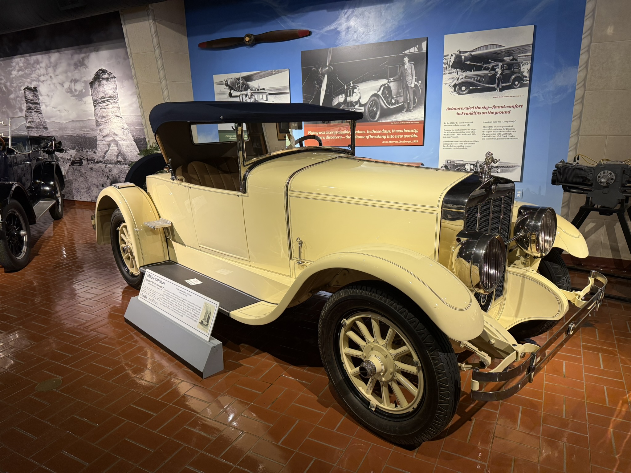 1925 Franklin Series 11 Sport Runabout in front of an aviation mural